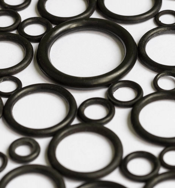 Large and Small Black O Rings Against a White Background